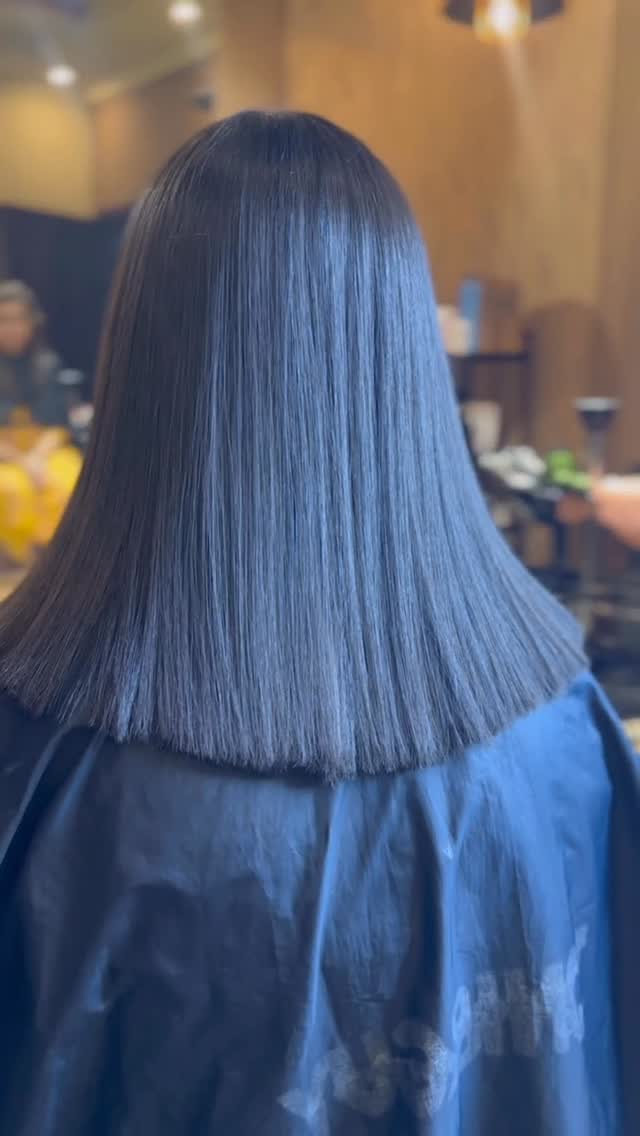 Blunt-cut glossy blue-black hair with a liquid keratin shine
