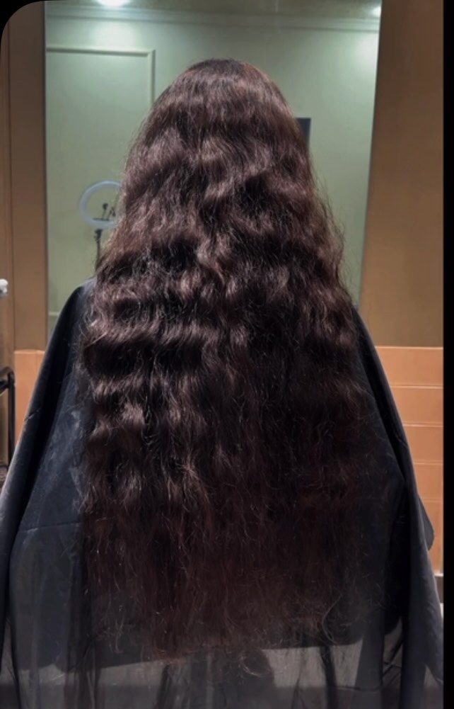 Very long dark wavy hair, photographed from behind in the studio